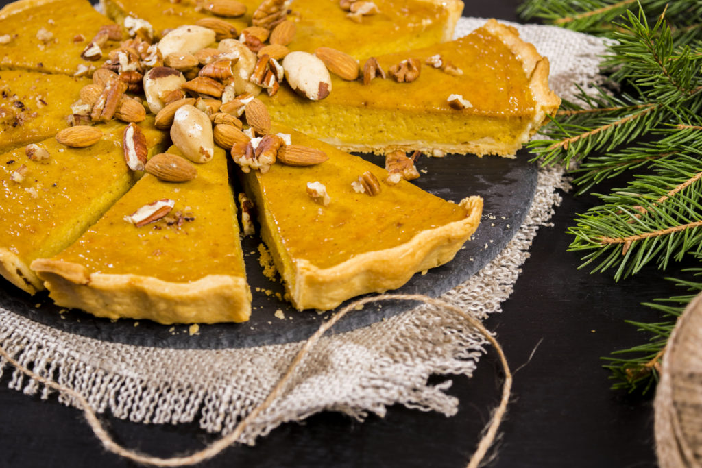 American pumpkin pie decorated with assorted nuts